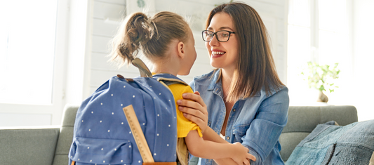 A smiling person speaks to a child